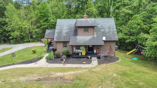 6334 Hansley Rd SE, Sugar Grove, OH 43155 - view of front of property with a front lawn, a chimney, covered porch, and a playground