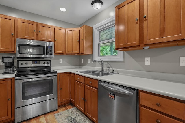 6334 Hansley Rd SE, Sugar Grove, OH 43155 - kitchen featuring stainless steel appliances, a sink, light wood-type flooring, light countertops, and brown cabinets