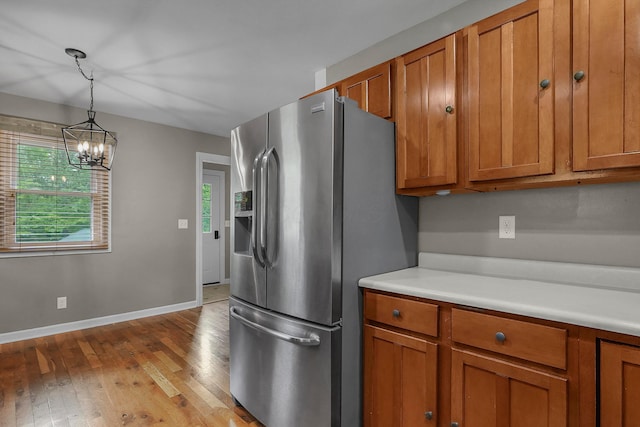 6334 Hansley Rd SE, Sugar Grove, OH 43155 - kitchen with stainless steel fridge, brown cabinetry, wood-type flooring, and light countertops