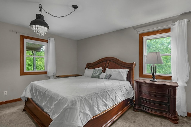 6334 Hansley Rd SE, Sugar Grove, OH 43155 - bedroom featuring carpet floors, multiple windows, baseboards, and a chandelier