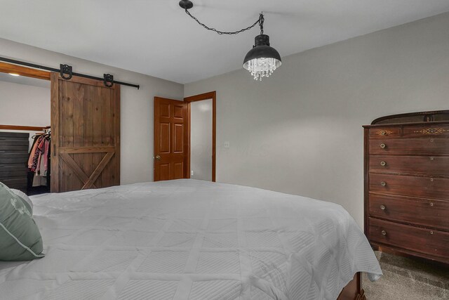 6334 Hansley Rd SE, Sugar Grove, OH 43155 - carpeted bedroom with a barn door and a walk in closet