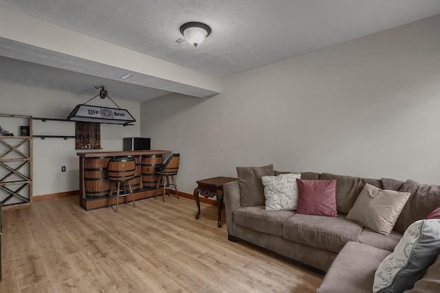 6334 Hansley Rd SE, Sugar Grove, OH 43155 - living room featuring wood finished floors, baseboards, a dry bar, and a textured ceiling