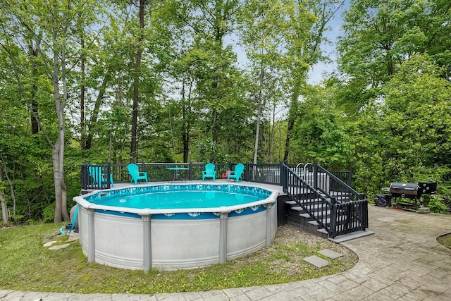 6334 Hansley Rd SE, Sugar Grove, OH 43155 - swimming pool with a wooden deck, stairway, grilling area, and view of scattered trees