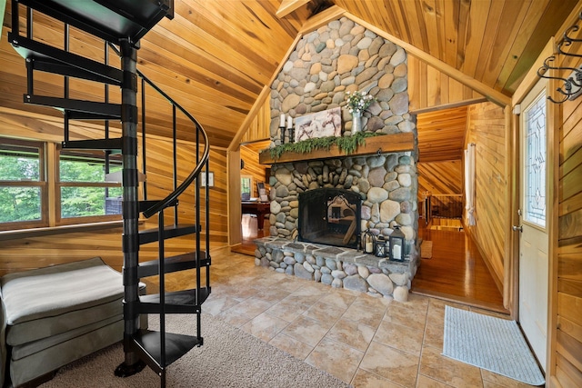 18156 Thompson Ridge Rd, Laurelville, OH 43135 - stairway featuring wood ceiling, lofted ceiling, wood walls, a fireplace, and tile patterned flooring