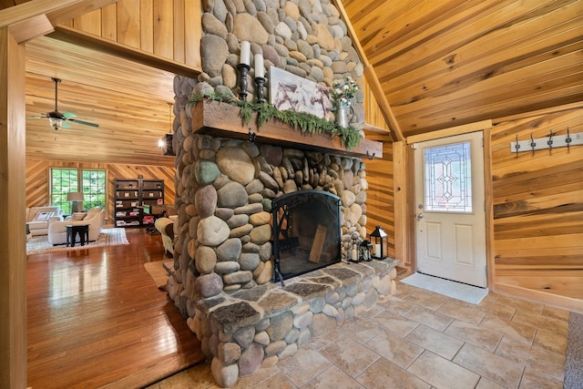 18156 Thompson Ridge Rd, Laurelville, OH 43135 - living room with wooden ceiling, plenty of natural light, wooden walls, a fireplace, and a ceiling fan