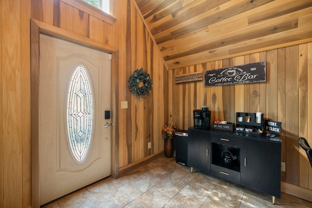 18156 Thompson Ridge Rd, Laurelville, OH 43135 - foyer entrance featuring vaulted ceiling, wood walls, wood ceiling, and light stone finish flooring