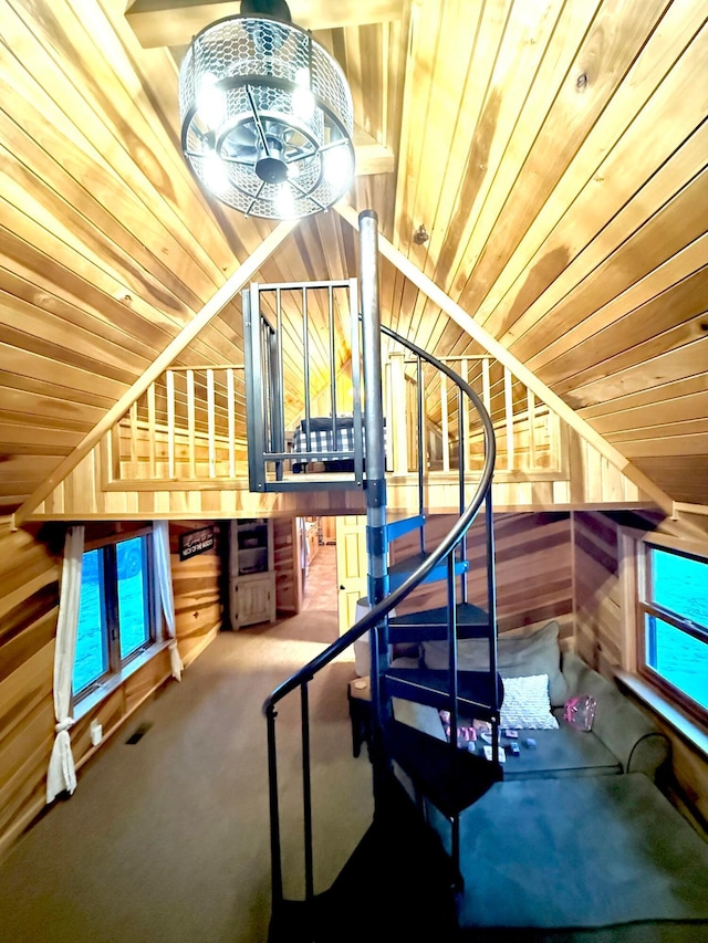 18156 Thompson Ridge Rd, Laurelville, OH 43135 - stairs with wood ceiling, wooden walls, vaulted ceiling, and carpet flooring