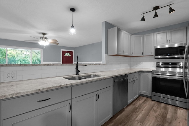2433 Nedra St, Grove City, OH 43123 - kitchen with appliances with stainless steel finishes, gray cabinetry, track lighting, and backsplash