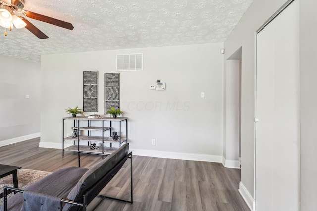 407 Yarmouth Ln, Columbus, OH 43228 - corridor featuring a textured ceiling, wood finished floors, and baseboards