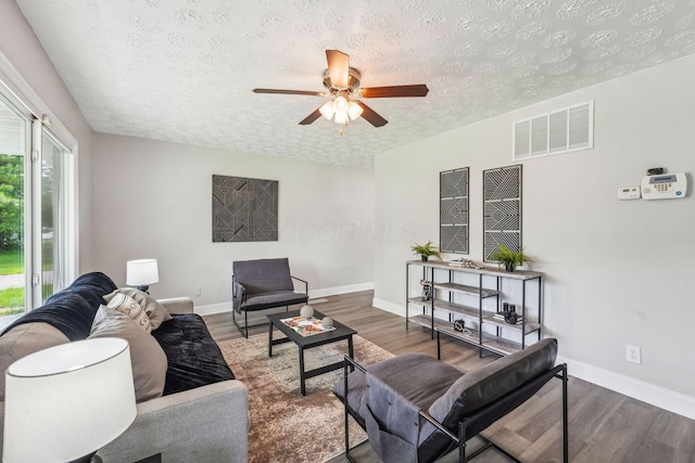 407 Yarmouth Ln, Columbus, OH 43228 - living area with a textured ceiling, wood finished floors, a ceiling fan, and baseboards