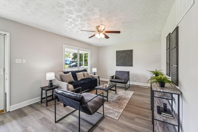 407 Yarmouth Ln, Columbus, OH 43228 - living room with a textured ceiling, a ceiling fan, wood finished floors, and baseboards
