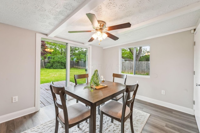 407 Yarmouth Ln, Columbus, OH 43228 - dining area with plenty of natural light, baseboards, wood finished floors, beamed ceiling, and a textured ceiling