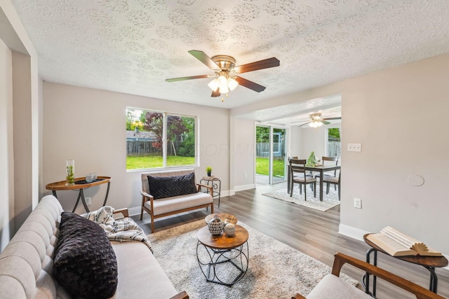 407 Yarmouth Ln, Columbus, OH 43228 - living area with wood finished floors, a ceiling fan, baseboards, and a textured ceiling