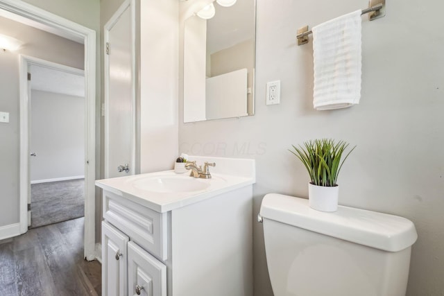 407 Yarmouth Ln, Columbus, OH 43228 - half bath with toilet, wood finished floors, vanity, and baseboards