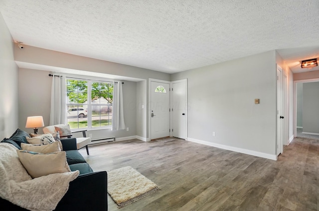 135 N Creekview Ct, Baltimore, OH 43105 - living room with wood finished floors, baseboards, a textured ceiling, and a baseboard heating unit