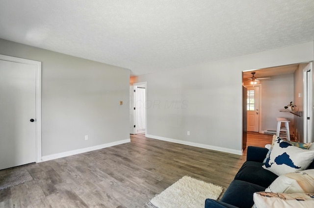 135 N Creekview Ct, Baltimore, OH 43105 - living area featuring wood finished floors, baseboards, a ceiling fan, and a textured ceiling