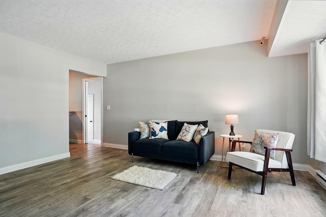 135 N Creekview Ct, Baltimore, OH 43105 - living room featuring wood finished floors, baseboards, and a textured ceiling