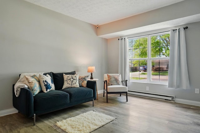 135 N Creekview Ct, Baltimore, OH 43105 - sitting room featuring a baseboard heating unit, wood finished floors, baseboards, and a textured ceiling