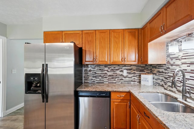 135 N Creekview Ct, Baltimore, OH 43105 - kitchen with stainless steel appliances, a sink, brown cabinets, and backsplash