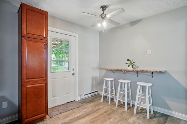 135 N Creekview Ct, Baltimore, OH 43105 - dining room featuring a baseboard radiator, light wood-type flooring, baseboards, and ceiling fan
