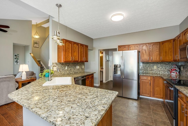 247 Trail E, Pataskala, OH 43062 - kitchen with appliances with stainless steel finishes, a peninsula, tasteful backsplash, brown cabinetry, and a textured ceiling