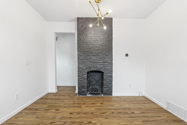 unfurnished living room with a fireplace, wood finished floors, and baseboards