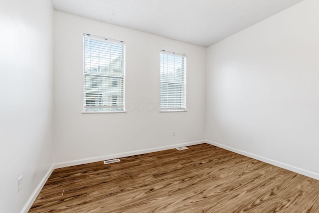 unfurnished room featuring wood finished floors and baseboards