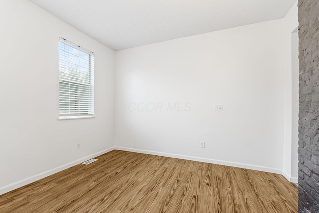 unfurnished room featuring light wood-style flooring and baseboards