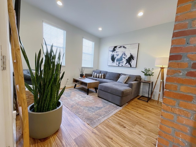 living room with light wood finished floors, baseboards, and recessed lighting