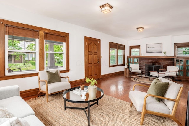 living room featuring plenty of natural light, wood finished floors, and baseboards