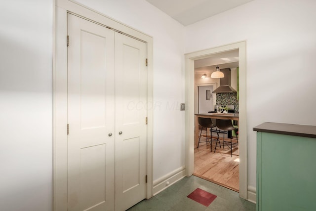 hall with tile patterned floors