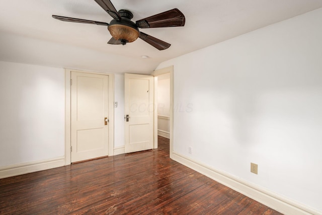 unfurnished bedroom featuring wood finished floors, baseboards, lofted ceiling, and a ceiling fan
