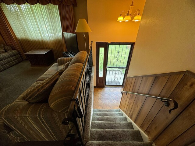 3457 Petzinger Rd, Columbus, OH 43232 - stairs featuring a chandelier and wainscoting