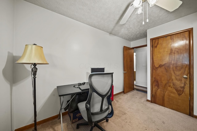 office area featuring carpet floors, ceiling fan, baseboards, and a textured ceiling