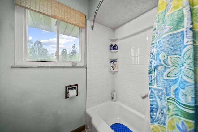 full bathroom with shower / bathtub combination with curtain and a textured ceiling
