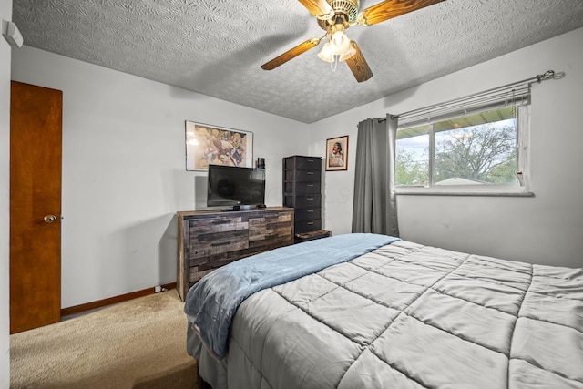 bedroom with carpet, a textured ceiling, ceiling fan, and baseboards