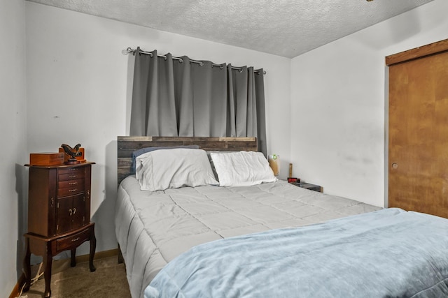 carpeted bedroom with a textured ceiling