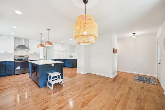 500 Cherrington Ct, Westerville, OH 43081 - kitchen with stainless steel electric range, wall chimney exhaust hood, blue cabinetry, baseboards, and recessed lighting