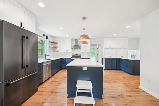 500 Cherrington Ct, Westerville, OH 43081 - kitchen featuring stainless steel appliances, wall chimney exhaust hood, a sink, light wood-style floors, and recessed lighting