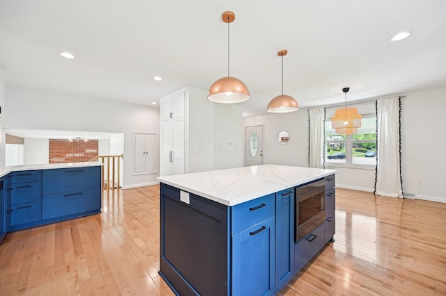 500 Cherrington Ct, Westerville, OH 43081 - kitchen with stainless steel microwave, blue cabinets, light wood finished floors, and recessed lighting