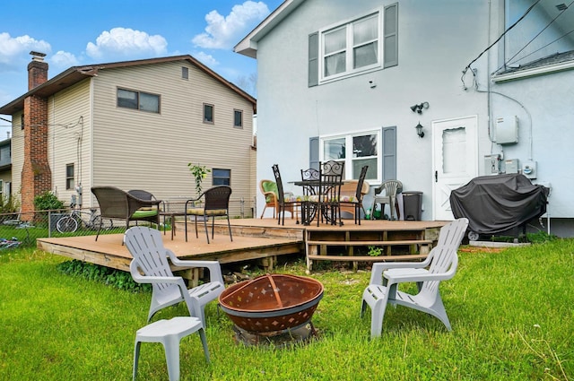 5508 Aspen Rd, Columbus, OH 43229 - rear view of property with a fire pit, a deck, stucco siding, and outdoor dining space