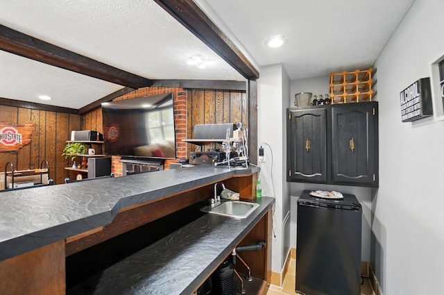 5508 Aspen Rd, Columbus, OH 43229 - kitchen with a sink, dark countertops, beamed ceiling, refrigerator, and recessed lighting