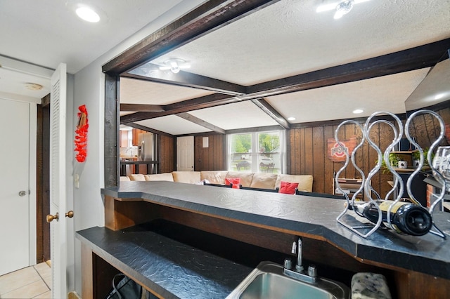 5508 Aspen Rd, Columbus, OH 43229 - kitchen featuring dark countertops, a sink, tile patterned flooring, beam ceiling, and recessed lighting
