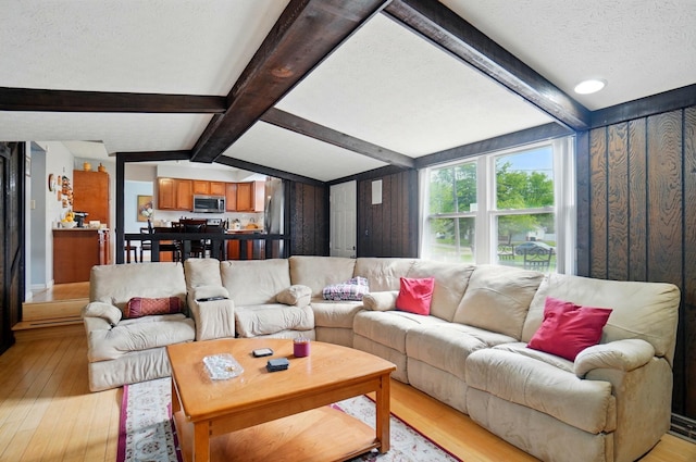 5508 Aspen Rd, Columbus, OH 43229 - living area with light wood finished floors, a textured ceiling, and baseboards