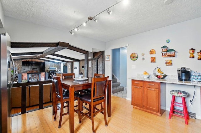 5508 Aspen Rd, Columbus, OH 43229 - dining area with light wood-style floors, a textured ceiling, and stairway