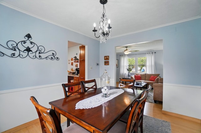 5508 Aspen Rd, Columbus, OH 43229 - dining space with ornamental molding, light wood-style flooring, a ceiling fan, baseboards, and a chandelier