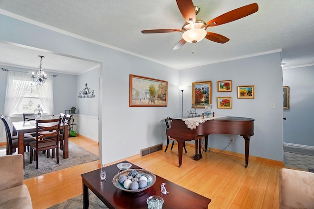 5508 Aspen Rd, Columbus, OH 43229 - living area featuring wood finished floors, a chandelier, ornamental molding, a ceiling fan, and baseboards