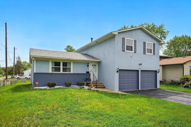 5508 Aspen Rd, Columbus, OH 43229 - tri-level home featuring an attached garage, driveway, a front lawn, stucco siding, and brick siding