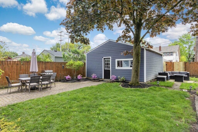 back of house featuring an outdoor living space, a patio, and an outdoor structure