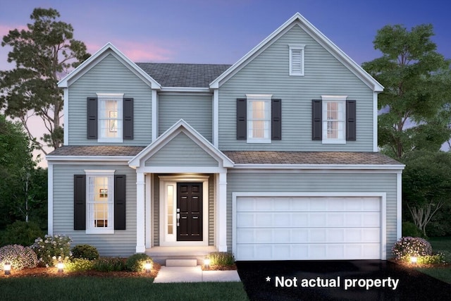 traditional-style home with a garage, roof with shingles, and asphalt driveway